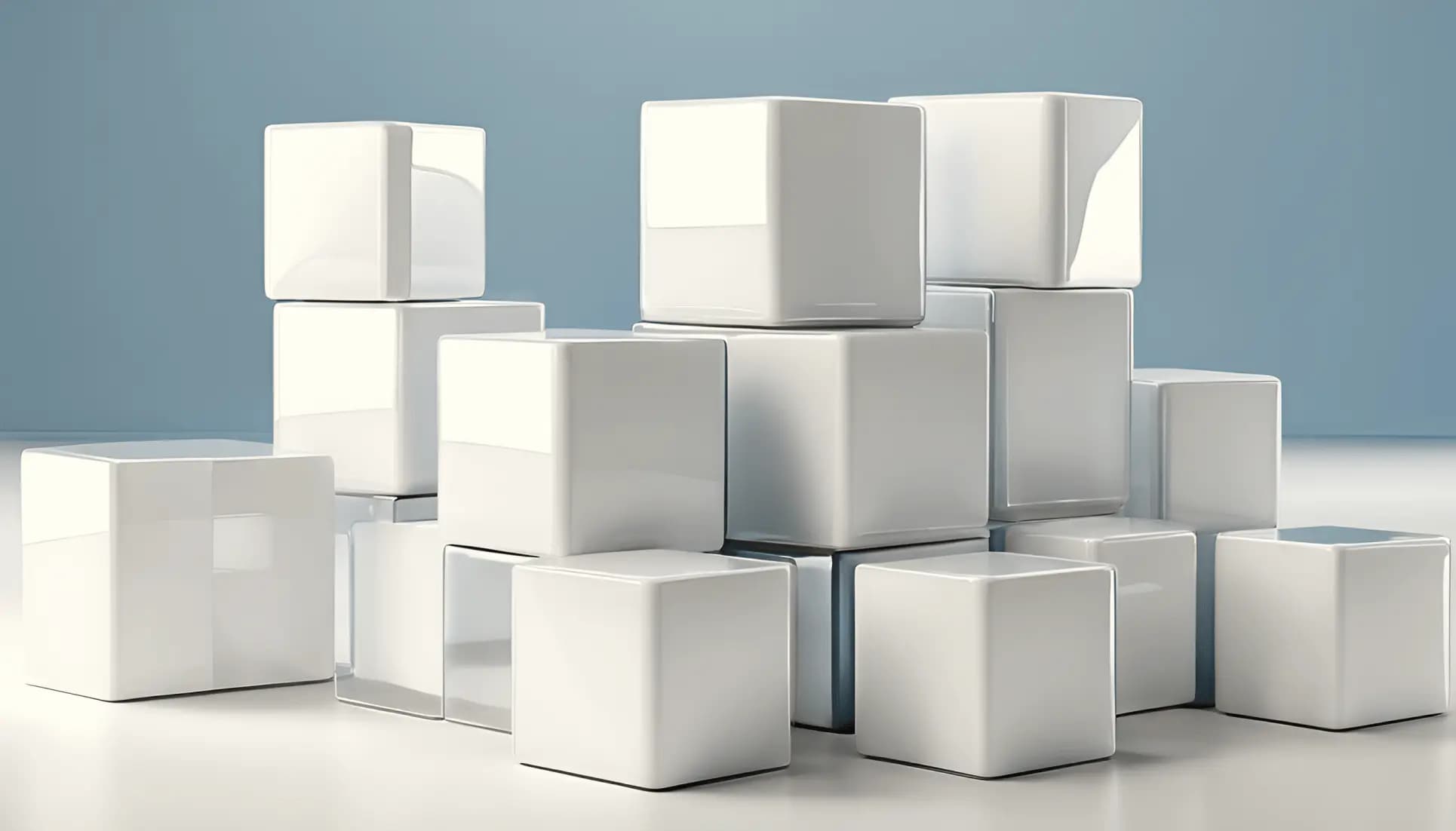 Stacked glossy white cubes arranged on a light surface.